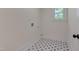 The well-lit laundry room features stylish patterned floors and a clean, functional space at 924 W Trinity Ave, Durham, NC 27701