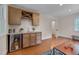 Entertainers wet bar with modern cabinetry, beverage fridge, and stylish finishes at 924 W Trinity Ave, Durham, NC 27701