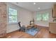 Bright living room featuring large windows, exposed brick wall, and cozy seating area at 924 W Trinity Ave, Durham, NC 27701