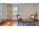 Bright living room featuring large windows, exposed brick wall, and cozy seating area at 924 W Trinity Ave, Durham, NC 27701