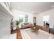 Bright living room with a decorative fireplace, and large windows overlooking greenery at 924 W Trinity Ave, Durham, NC 27701