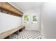 Bright mudroom features a bench with hooks and a starburst patterned floor at 924 W Trinity Ave, Durham, NC 27701