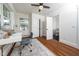 Bright office space with desk, chair, a window, hardwood floors and view into adjacent bathroom at 924 W Trinity Ave, Durham, NC 27701