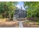Charming rear home exterior with a newly built deck, wooden fence and beautifully manicured yard at 924 W Trinity Ave, Durham, NC 27701