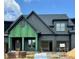 New construction home featuring a gray exterior, an attached two-car garage and a covered front porch at 1025 Coldspring Circle, Durham, NC 27705