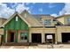 New construction townhome with yellow siding, double garage, and landscaping underway showcases modern design at 1025 Coldspring Circle, Durham, NC 27705
