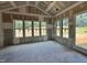 Under construction sun room showcasing drywall, multiple windows and a patio door at 1025 Coldspring Circle, Durham, NC 27705