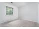 Bright bedroom with a large window and neutral carpet at 105 Sir Richard Ln, Chapel Hill, NC 27517