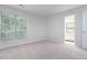 Bright bedroom featuring neutral carpet, a large window, and an en-suite bathroom at 105 Sir Richard Ln, Chapel Hill, NC 27517