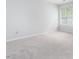 Light-filled bedroom with neutral carpet, white walls, and a large window at 105 Sir Richard Ln, Chapel Hill, NC 27517