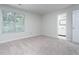 Carpeted bedroom featuring a window and a doorway to the en-suite bathroom at 105 Sir Richard Ln, Chapel Hill, NC 27517