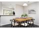 Bright dining room with a wooden table and view to the kitchen at 105 Sir Richard Ln, Chapel Hill, NC 27517