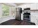 Bright kitchen featuring stainless steel appliances and dark wood flooring at 105 Sir Richard Ln, Chapel Hill, NC 27517