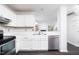 Modern kitchen featuring stainless steel appliances, white countertops, and ample cabinet space at 105 Sir Richard Ln, Chapel Hill, NC 27517