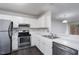 Well-lit kitchen with white cabinets, stainless steel appliances, and open design at 105 Sir Richard Ln, Chapel Hill, NC 27517