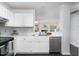 Bright kitchen with white cabinets, stainless steel appliances and a view to the Gathering room at 105 Sir Richard Ln, Chapel Hill, NC 27517