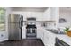 Bright kitchen featuring stainless steel appliances, white cabinetry, and modern countertops at 105 Sir Richard Ln, Chapel Hill, NC 27517