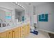Bright bathroom with double sinks, tile floors, and blue towels at 106 Oak Rd, Butner, NC 27509