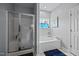 This bathroom has a tub and shower with a blue rug and blue curtain at 106 Oak Rd, Butner, NC 27509