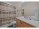 Bathroom features a single sink with a white countertop, a toilet, and a shower with patterned shower curtain at 106 Oak Rd, Butner, NC 27509
