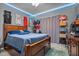 This is a bedroom with a wood frame bed and several jerseys and sneakers hung on the wall at 106 Oak Rd, Butner, NC 27509