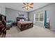 Comfortable bedroom with ceiling fan, large window, and neutral color scheme at 106 Oak Rd, Butner, NC 27509