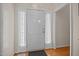 Bright entryway featuring wood floors, white trim, and a neutral color palette at 106 Oak Rd, Butner, NC 27509