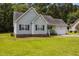 Charming single-story home featuring a manicured lawn, and lush landscaping at 106 Oak Rd, Butner, NC 27509