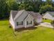 Charming single-story home featuring a manicured lawn, and lush landscaping at 106 Oak Rd, Butner, NC 27509