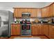 Well-equipped kitchen features stainless steel appliances, wood cabinets, and black countertops at 106 Oak Rd, Butner, NC 27509