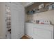 A laundry room with a washer, dryer and shelving with cleaning supplies at 106 Oak Rd, Butner, NC 27509