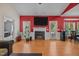 Bright living room featuring a fireplace, hardwood floors, and access to the outdoors at 106 Oak Rd, Butner, NC 27509