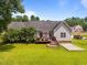 This single Gathering home shows a deck with outdoor seating and a grill, with a quaint backyard space at 106 Oak Rd, Butner, NC 27509