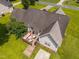 Aerial shot shows a nice deck with outdoor seating and a fire pit in the backyard at 106 Oak Rd, Butner, NC 27509