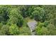 Aerial view of home nestled in trees, showcasing surrounding property at 109 Springwood Dr, Wake Forest, NC 27587