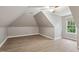 Attic room with ceiling fan, wood-look flooring, and natural light at 109 Springwood Dr, Wake Forest, NC 27587