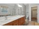Bright bathroom with dual vanity, shower, and tub with window at 109 Springwood Dr, Wake Forest, NC 27587