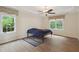 Bedroom with wood floors, two windows, and a ceiling fan, offering a bright and airy feel at 109 Springwood Dr, Wake Forest, NC 27587