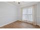 Comfortable bedroom with wood-look flooring and a large window for ample natural light at 109 Springwood Dr, Wake Forest, NC 27587