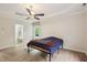Primary bedroom suite features wood flooring, tray ceiling, and a view into a relaxing bathroom at 109 Springwood Dr, Wake Forest, NC 27587