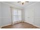 Bright bedroom features wood floors, neutral paint, modern trim, and natural light from the large window at 109 Springwood Dr, Wake Forest, NC 27587