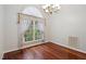 Bright dining room featuring hardwood floors and a large window with elegant sheer curtains at 109 Springwood Dr, Wake Forest, NC 27587