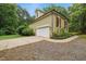 Home featuring an attached garage with a concrete driveway and lush landscaping at 109 Springwood Dr, Wake Forest, NC 27587