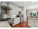 Gourmet kitchen featuring stainless appliances, granite countertops, and ample white cabinetry at 109 Springwood Dr, Wake Forest, NC 27587