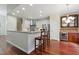 Open concept kitchen features wood floors, pendant lighting, and stainless steel appliances at 109 Springwood Dr, Wake Forest, NC 27587