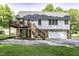 Back of house featuring a deck, backyard and a spacious two-car garage at 1112 Newberry Dr, Mebane, NC 27302
