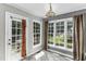 Bright breakfast nook has large windows offering backyard views and an exterior door at 1112 Newberry Dr, Mebane, NC 27302