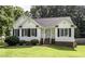 Charming home featuring a well-manicured lawn and complemented by black shutters at 1112 Newberry Dr, Mebane, NC 27302