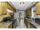 Galley kitchen featuring tiled floors, wooden cabinets and countertops, and white appliances at 1112 Newberry Dr, Mebane, NC 27302