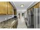 Traditional eat-in kitchen features wooden cabinets, stainless appliances, and double doors leading to outdoor deck at 1112 Newberry Dr, Mebane, NC 27302
